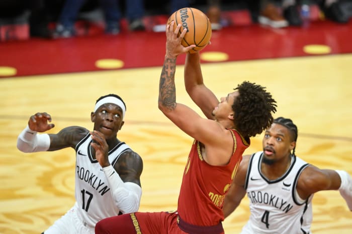 Mar 10, 2024; Cleveland, Ohio, USA; Cleveland Cavaliers guard Craig Porter Jr. (9) drives to the basket between Brooklyn Nets guard Dennis Schroder (17) and guard Dennis Smith Jr. (4) in the third quarter at Rocket Mortgage FieldHouse.